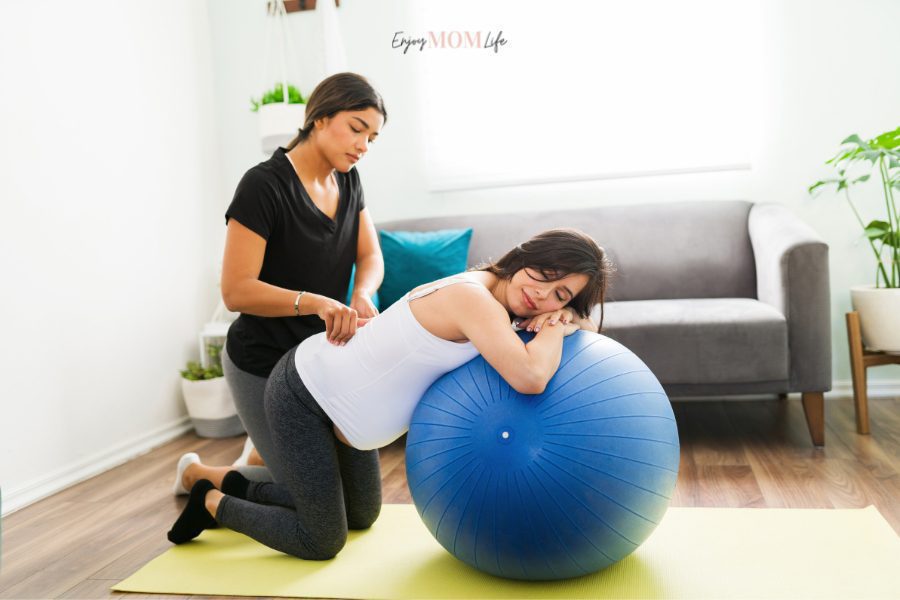 doula providing support with birthing ball